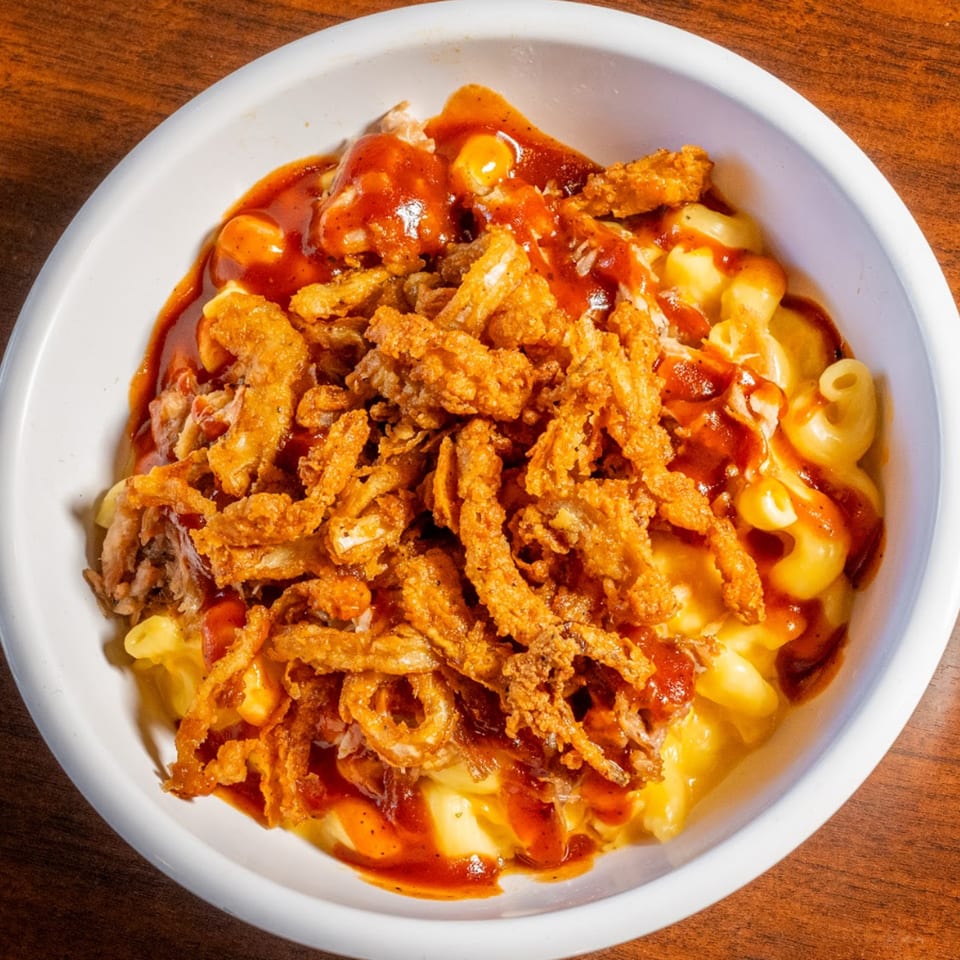 Scores on 33rd's mac and cheese topped with pulled pork, crispy onions, and BBQ sauce.